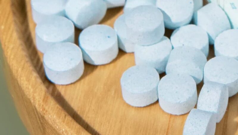 Mouthwash tablets on a wooden table